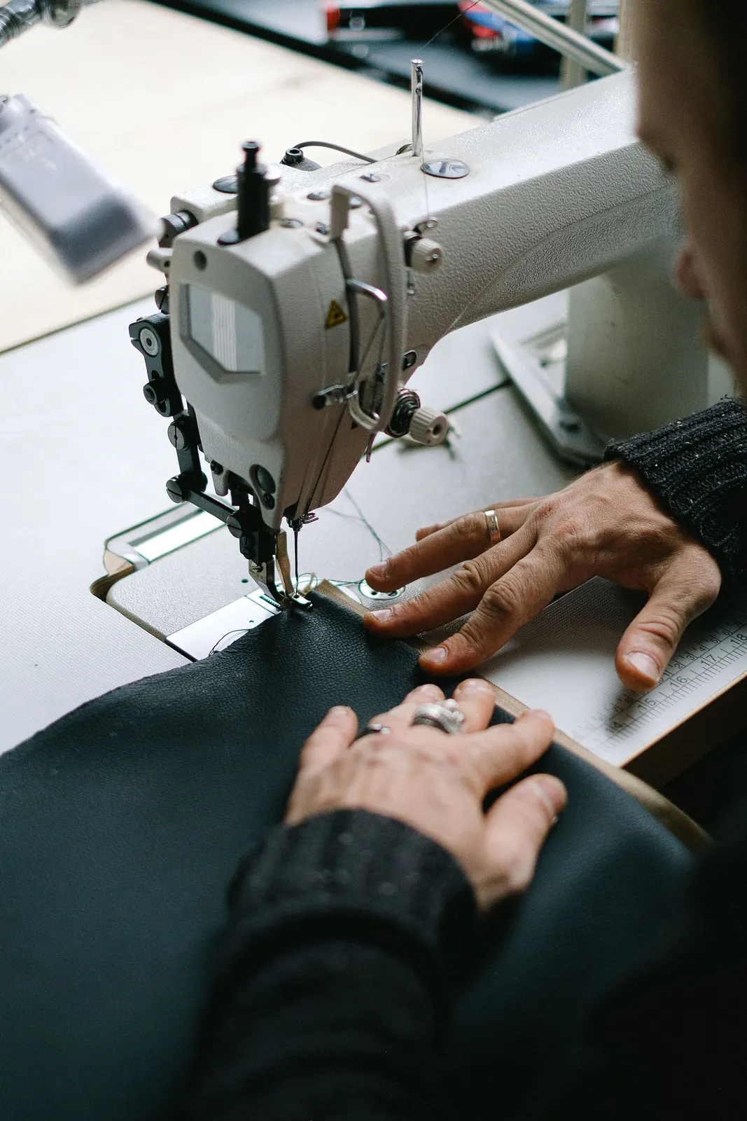 Confección de material negro en máquina de coser